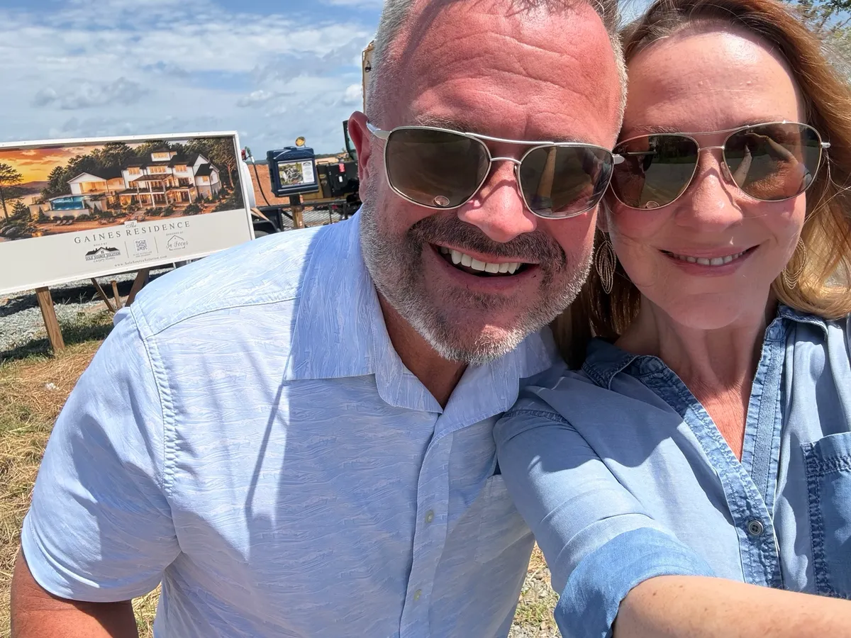 Chris and Mary Kate at the construction site with the Gaines Residence sign behind them