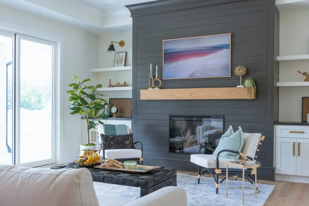 Smith Mountain Lake living room with a dark fireplace wall and light upholstered chairs